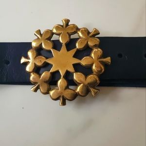 Antique brass belt buckle on blue leather.